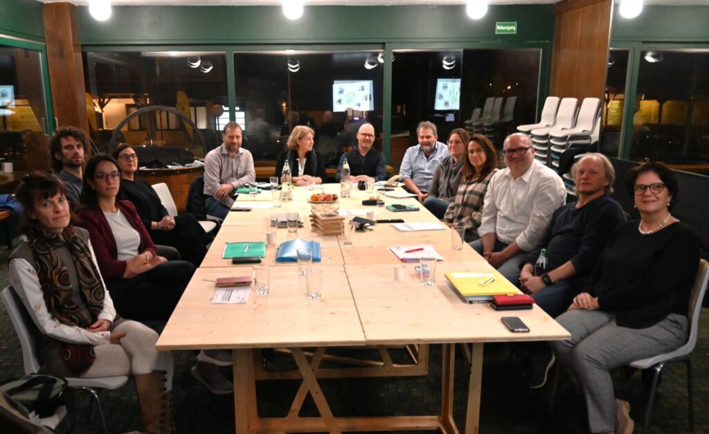 Group of people at a meeting around a long table